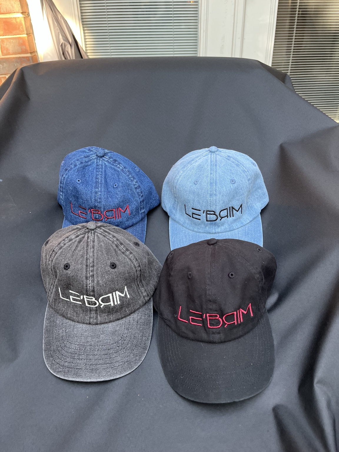Four real LE’BRIM embroidered denim and black caps